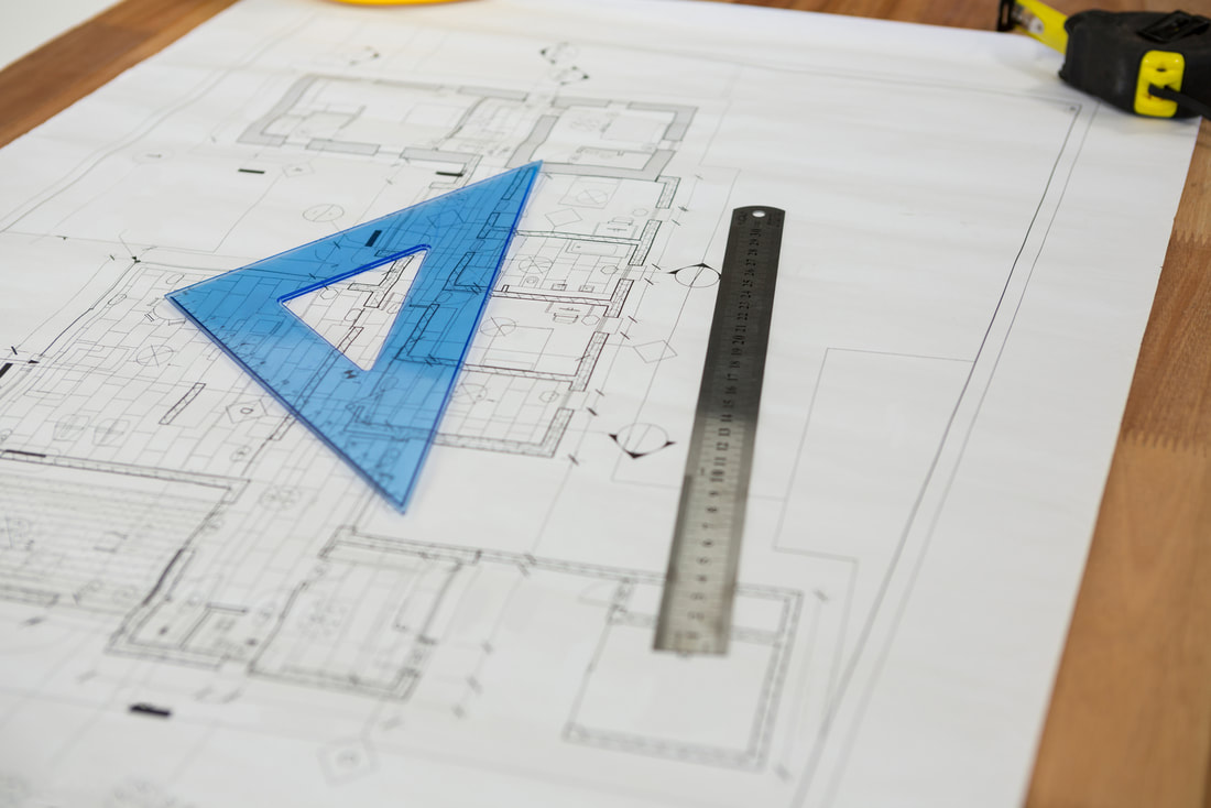 ADU plans with protractor and ruler on top of design