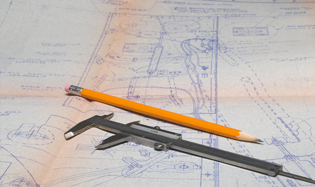 ADU blueprint with caliper and pencil
